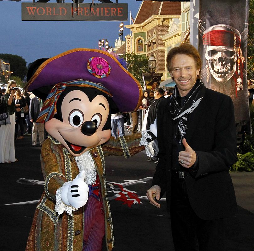 Producer Jerry Bruckheimer poses with the Disney character Mickey Mouse at the premiere of Pirates of the Caribbean: On Stranger Tides at Disneyland in Anaheim