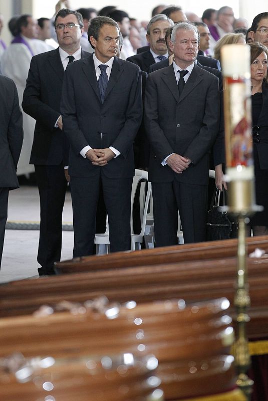 Spain's Prime Minister Zapatero stands with Murcia regional government president Valcarcel during a funeral ceremony for earthquake victims in Lorca