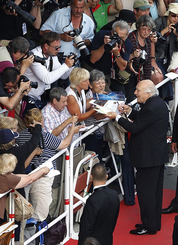 Cast member Michel Piccoli signs autographs on the red carpet for the screening of the film Habemus Papam in competition at the 64th Cannes Film Festival