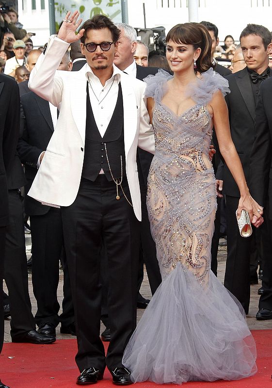 Cast members Depp and Cruz pose as they arrive on the red carpet at the 64th Cannes Film Festival