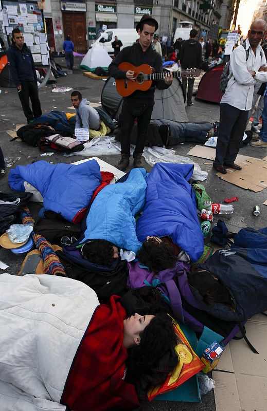 Demonstrators camp out in Madrid's Puerta del Sol during seventh day of protests