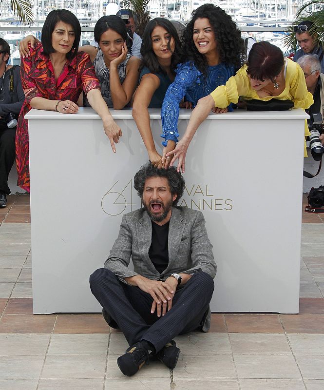 Director Mihaileanu and cast members pose during a photocall for the film La Source des Femmes at the 64th Cannes Film Festival