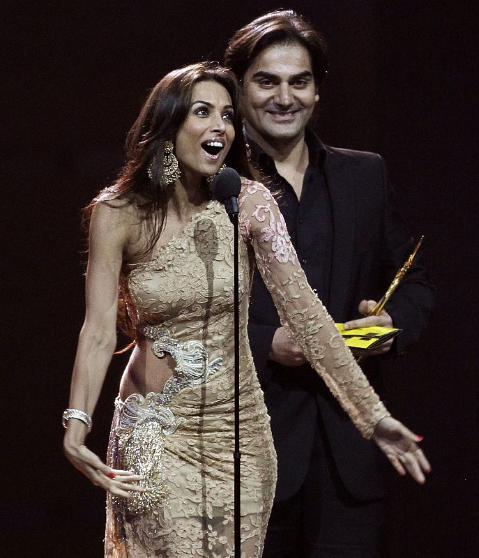 Khan accepts his award for best picture for his work in "Dabangg" as his wife Malaika talks during the IIFA awards show in Toronto