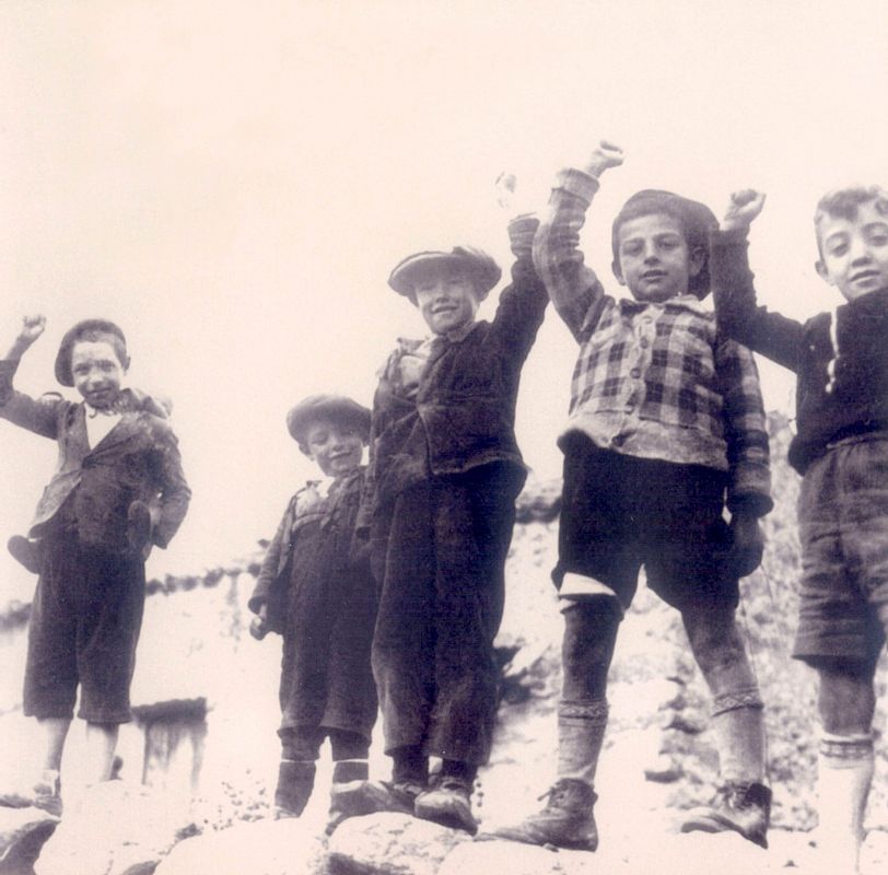 Niños saludando con el puños en alto en la zona republicana