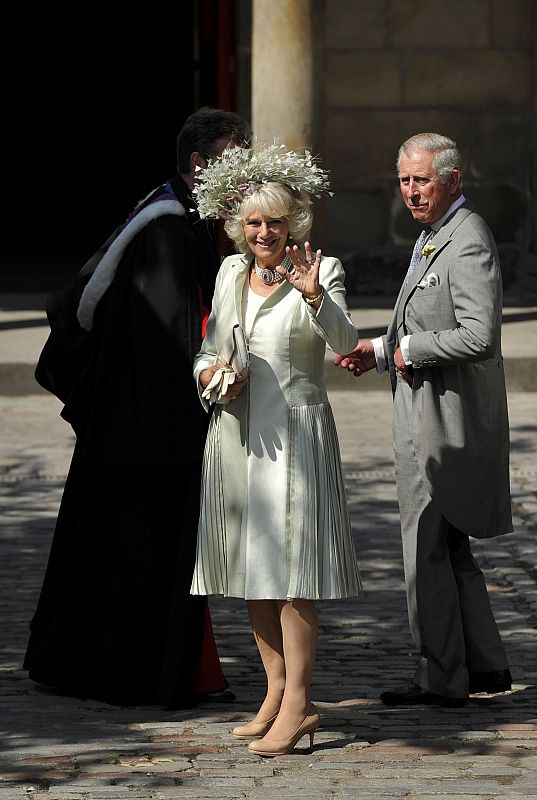 Camilla Duchess of Cornwall waves as she arrives with Prince Charles before the marriage of Zara Phillips and Mike Tindall at Canongate Kirk in Edinburgh