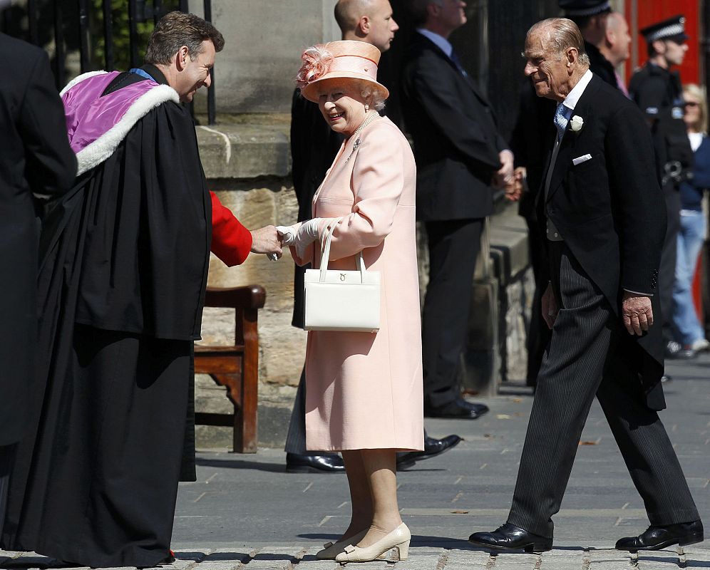 Reverend Neil Gardner greets Britain's Queen Elizabeth and Prince Philip before the marriage of their eldest granddaughter Zara Phillips to Mike Tindall at Canongate Kirk in Edinburgh