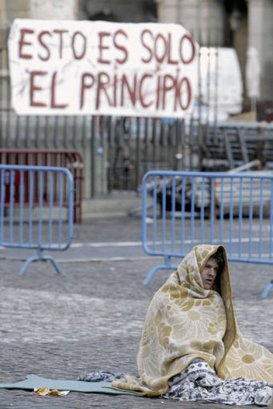 Un "indignado" en la Plaza Mayor de Madrid, después de que unos treinta de ellos pasara la noche en el lugar, poco antes de ser desalojados por la Policía Municipal, que les obligó a retirarse a la calle de Toledo