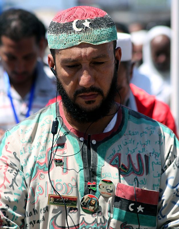 Un hombre vistiendo los colores de la nueva bandera libia durante el rezo del mediodía