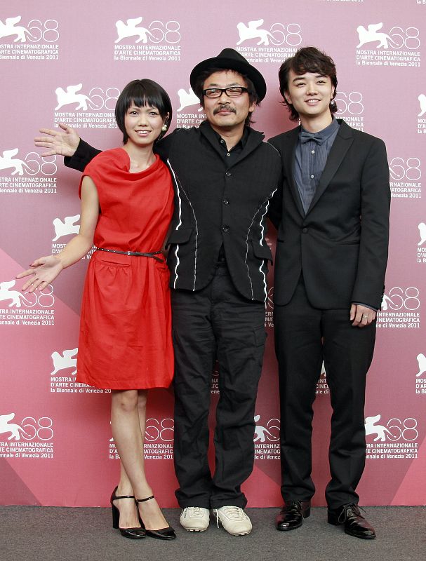 Director  Sono gestures as he poses with cast members Sometani and Nikaidou during a photocall for their film Himizu at the 68th Venice Film Festival