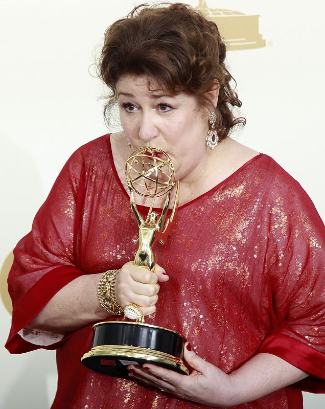 Actress Margo Martindale kisses her Emmy award backstage in Los Angeles