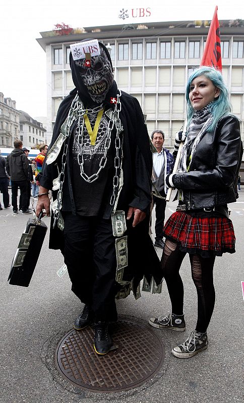 Demonstrators stand in front of the UBS building during the "Occupy Paradeplatz" protest in Zurich