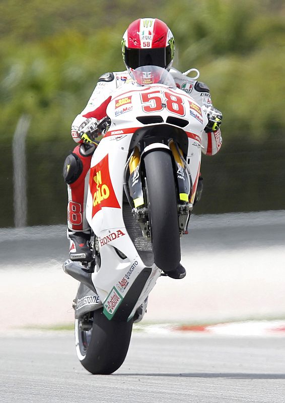 File photo of Honda MotoGP rider Simoncelli doing a wheelie after the qualifying session at the Malaysian Grand Prix at Sepang International Circuit