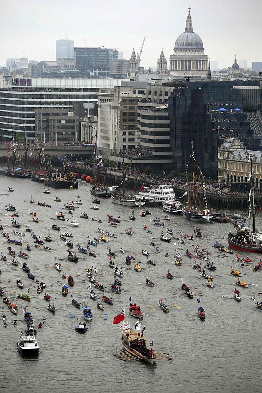 The 'Gloriana' leads the hand-powered craft towards Tower Bridge, during Queen Elizabeth's Thames river pageant during her Diamond Jubilee in London