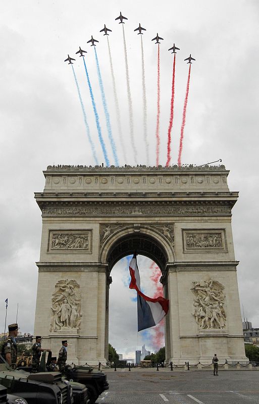 Alphajet planes from the Patrouille de France fly over the Arc de Triomphe during the traditional Bastille Day military parade in Paris