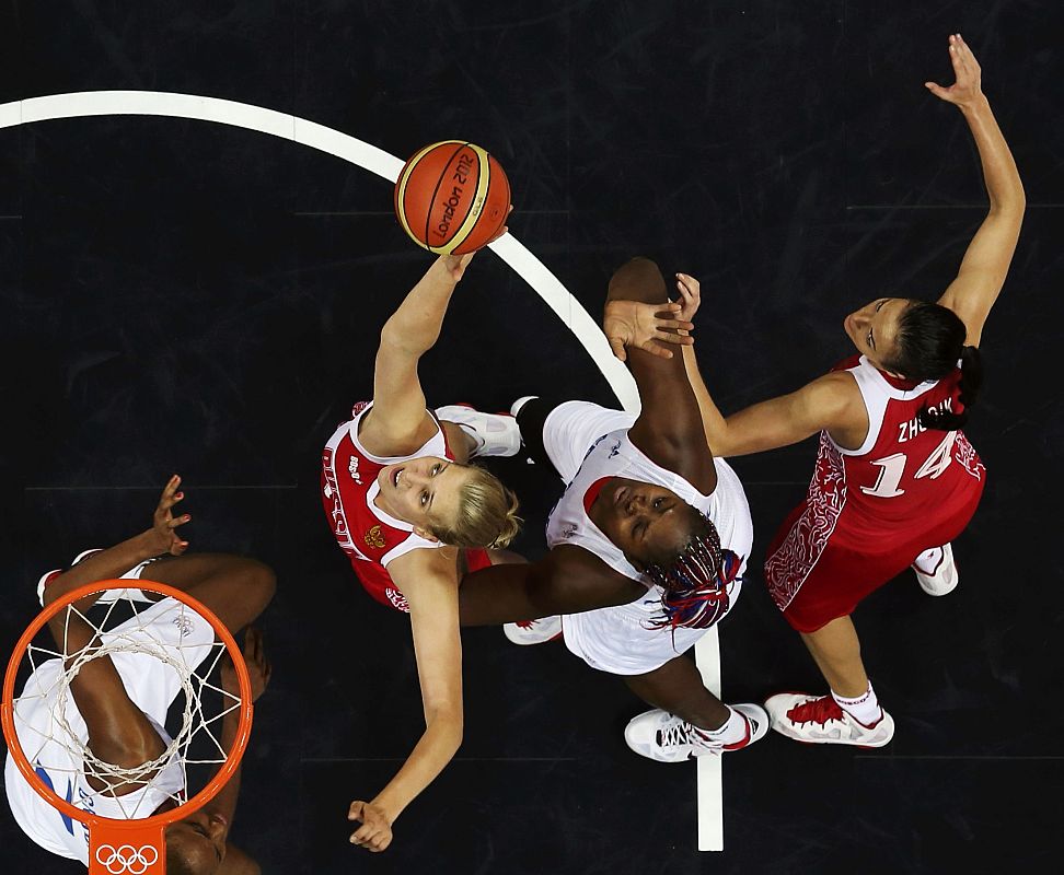 Russia's Natalya Vieru and Natalya Zhedik battle for the basket against France's Isabelle Yacoubou and Sandrine Gruda during their women's preliminary round Group B basketball match at the Basketball Arena during the London 2012 Olympic Games