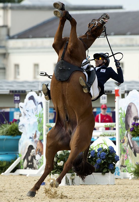 El jinete surcoreano Hwang Woojin pierde el control de su caballo durante la prueba del Pentathlon moderno.
