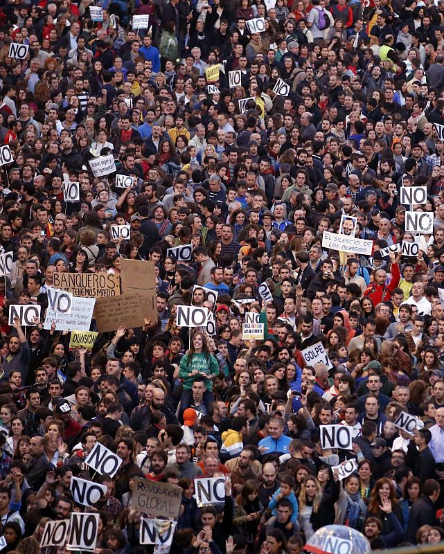 Protestors shout slogans as they fill up Neptuno Square during a demonstration against government austerity measures in Madrid