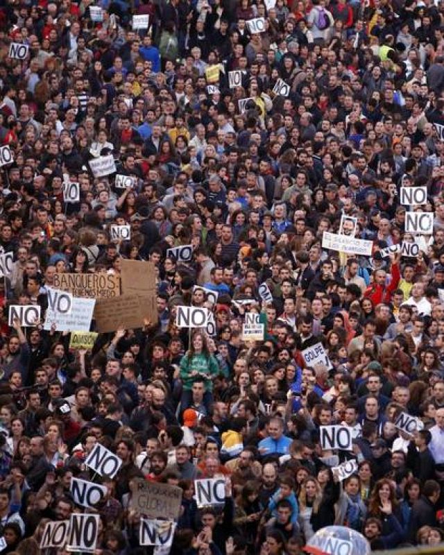 Protestors shout slogans as they fill up Neptuno Square during a demonstration against government austerity measures in Madrid