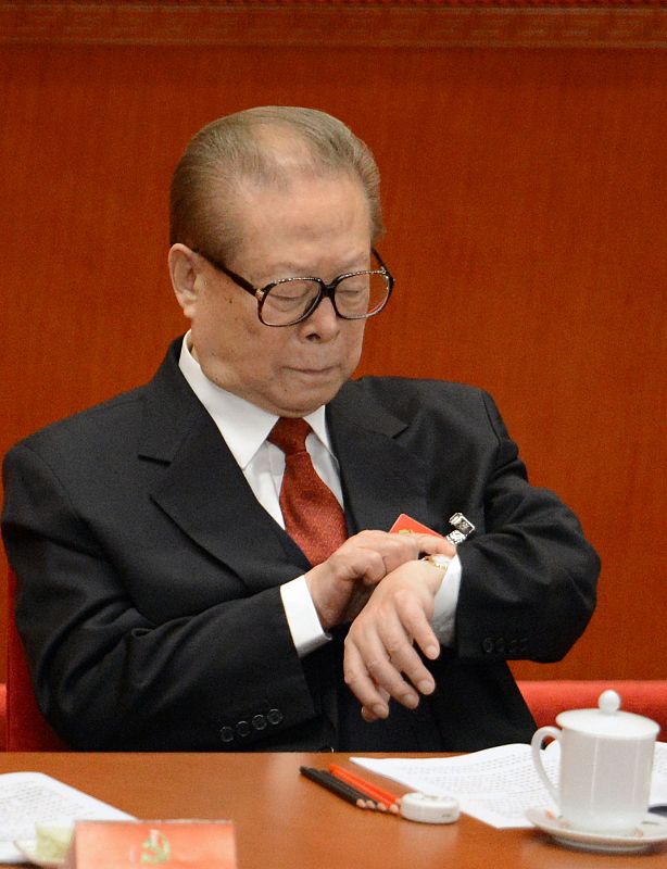 Jiang Zemin consulta su reloj momentos antes del discurso inaugural de Hu Jintao.