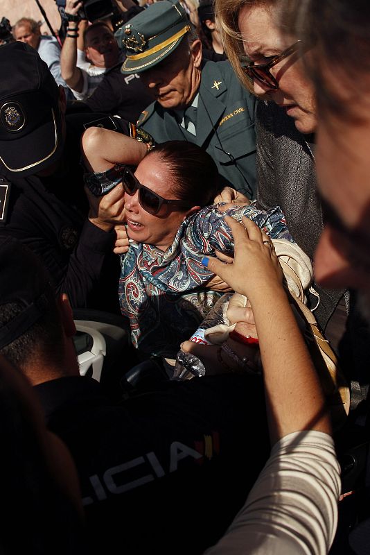 Spanish singer Pantoja is carried to a car after she collapsed while leaving a court after listening to the tribunal's sentence of her trial in Malaga