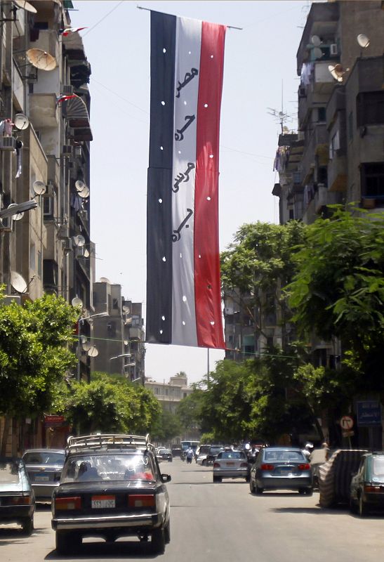 An Egyptian flag with the words reading "Egypt free, Mursi out" hangs in a street in Cairo