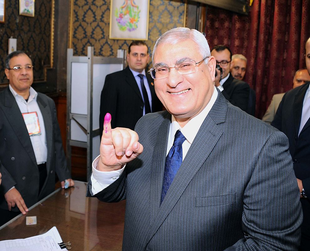 El presidente provisional egipcio, Adly Mansour, muestra el dedo tras votar en El Cairo