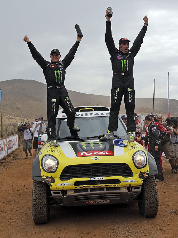 Roma of Spain and his co-driver Perin of France celebrate on their Mini after they won the sixth South American edition of the Dakar Rally 2014 in Valparaiso