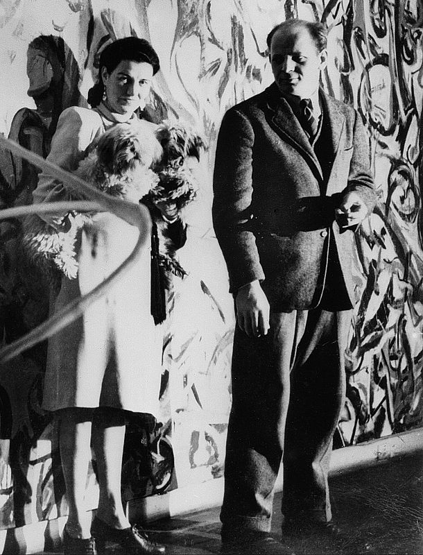 Peggy Guggenheim and Jackson Pollock, standing in front of the mural Peggy commisioned in 1943 for her New York apartment