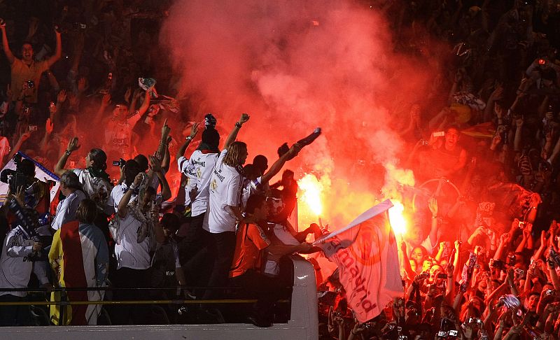 Real Madrid's players celebrate in front of crowd at Cibeles fountain in central Madrid