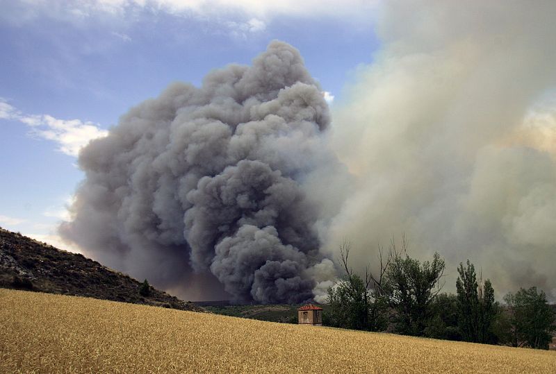 Smoke rises from a burnt area in the central Spanish town of Santa Maria del Espino.