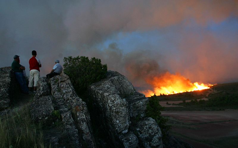 People watch a forest fire near the central Spanish village of Santa Maria del Espino near Guadalajara.