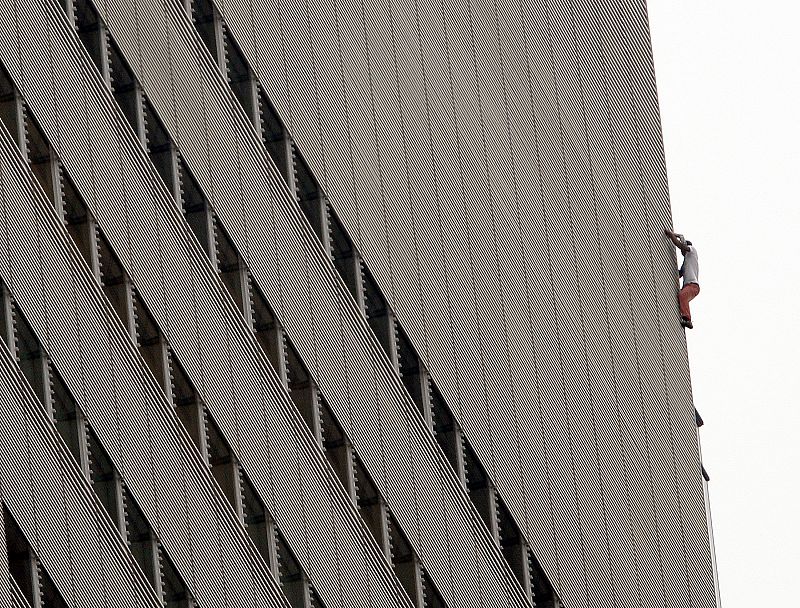 An unidentified climber scales the New York Times building in New York