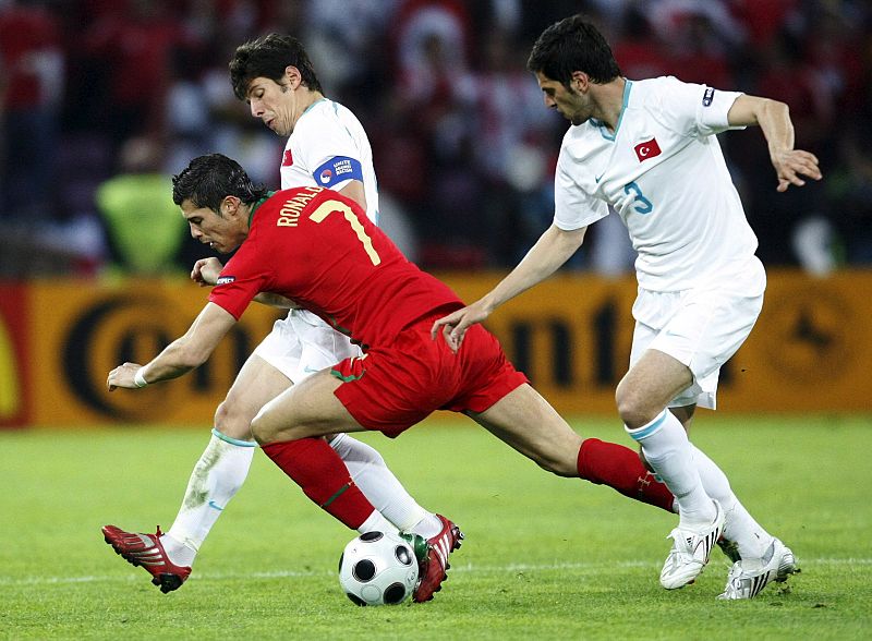 El jugador de Portugal Cristiano Ronaldo disputa el balón con Emre Beloezoglu y Hakan Balta, de Turquía .