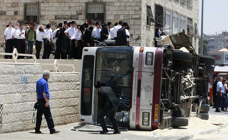 Ultra-Orthodox Jews stand near scene of attack in Jerusalem