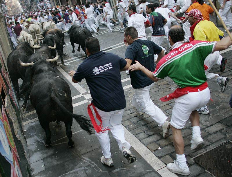 Runners are chased by Jandilla fighting bulls on the fifth day of the running of the bulls during the San Fermin festival in Pamplona