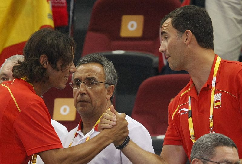 Spanish tennis player Rafael Nadal greets Spain's Prince Felipe during the men's Group B basketball game between Spain and Greece at the Beijing 2008 Olympic Games