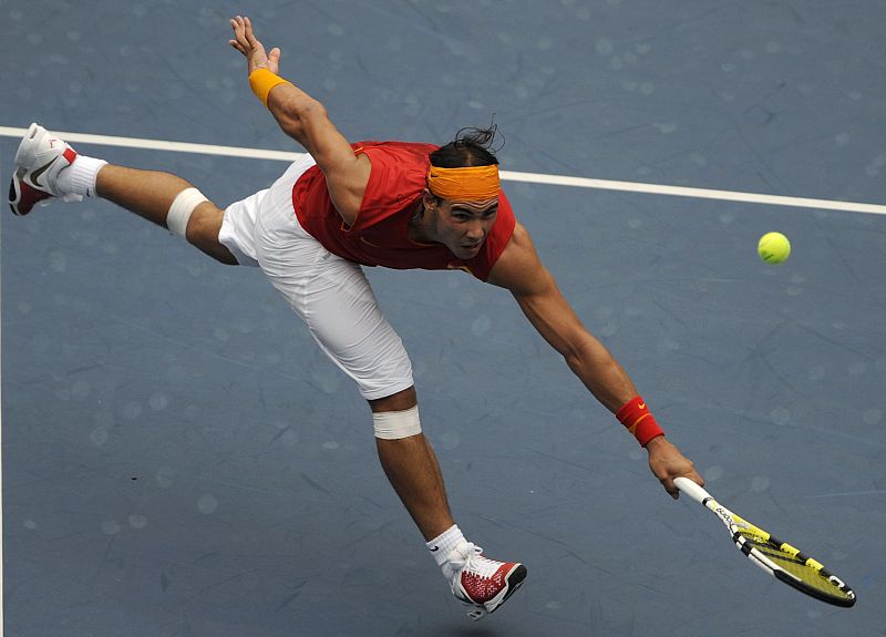 Rafael Nadal of Spain returns the ball to Potito Starace of Italy during their men's first round tennis match at the Beijing 2008 Olympic Games