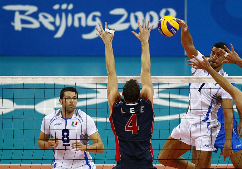 Italy's Mastrangelo spikes watched by Cisolla against Lee of the U.S. during their men's preliminary pool A volleyball match at the Beijing 2008 Olympic Games