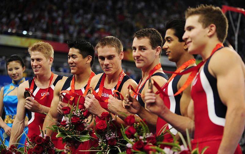 Members of the U.S. team pose on the podium after winning the men's team artistic gymnastics bronze medal at the Beijing 2008 Olympic Games