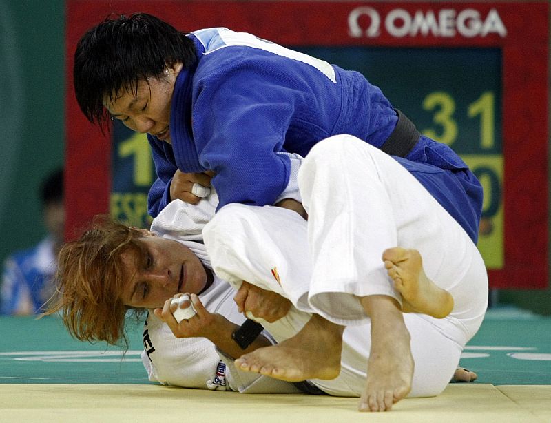 Yang of China fights with San Miguel of Spain during their women's -78kg final of the table judo match at the Beijing 2008 Olympic Games