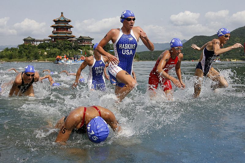 Competitors start their swim at the Ming Tomb reservoir in the Changping District of northern Beijing during the women's triathlon competition of the Beijing 2008 Olympic Games