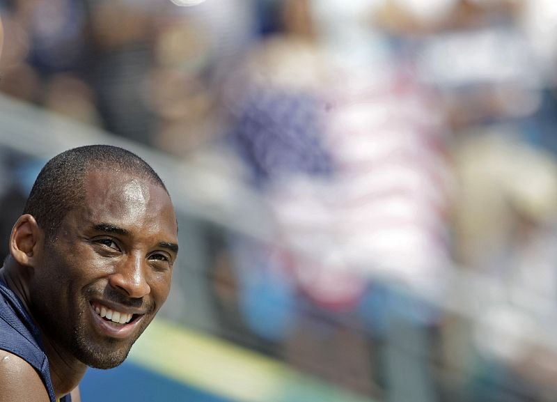 Basketball player Kobe Bryant of the U.S. watches the women's beach volleyball semifinal match between Brazil and the U.S. at the Beijing 2008 Olympic Games