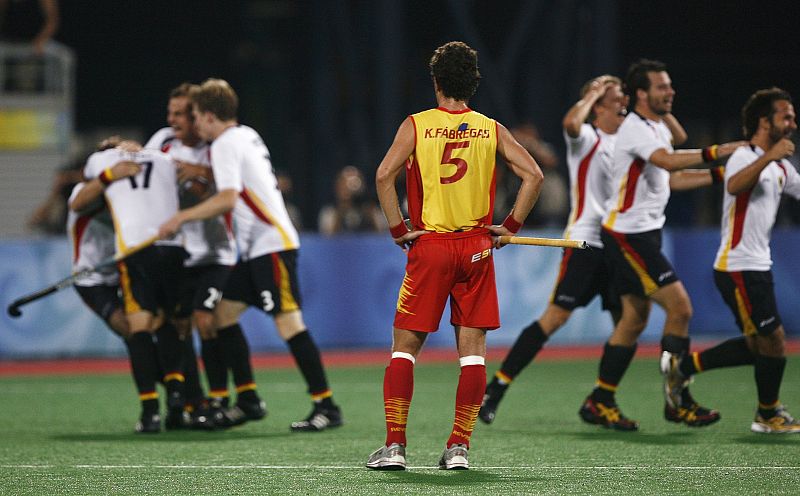 Francisco Fabregas of Spain watches Germany players celebrate their win in their men's hockey gold medal match at the Beijing 2008 Olympic Games