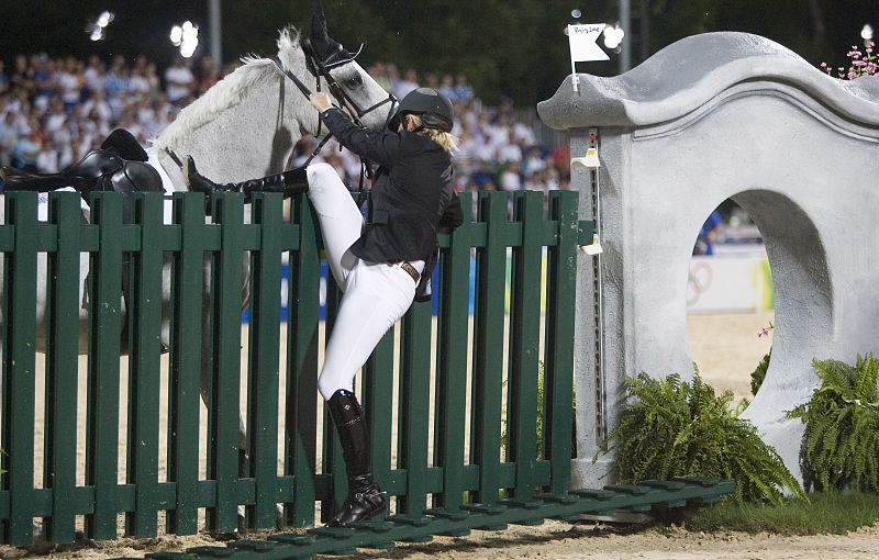 New Zealand's Katie McVean falls off Forest after he refused to jump a fence during the equestrian jumping individual first qualifier at the Beijing 2008 Olympic Games in Hong Kong