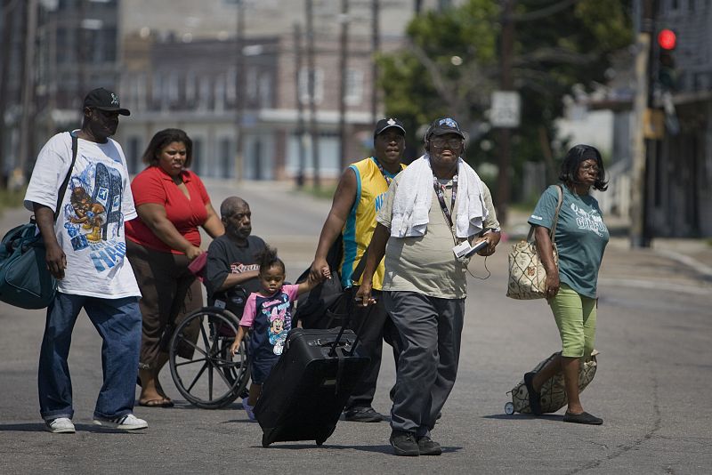 Residents walk towards an evacuation center in New Orleans