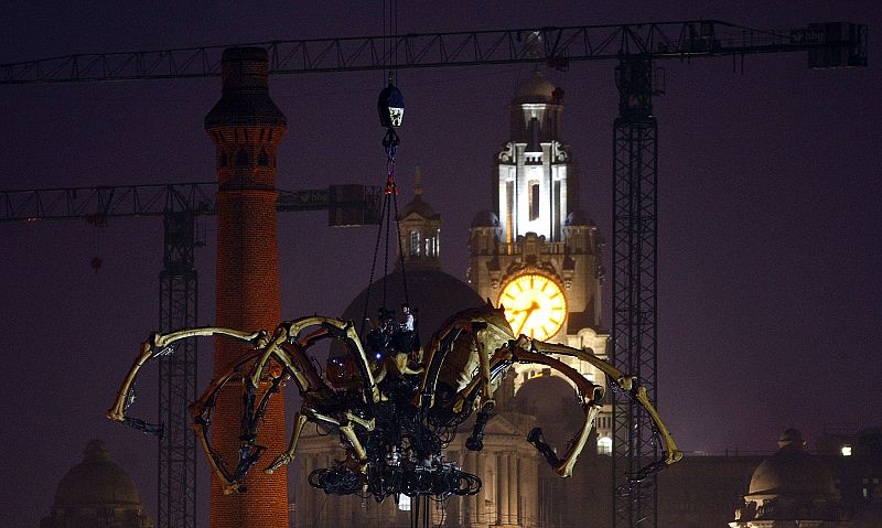 A giant mechanical spider, part of a piece of 'free theatre' by French company La Machine entitled 'Les Mecaniques Servants', is lowered into Liverpool's Salthouse Dock