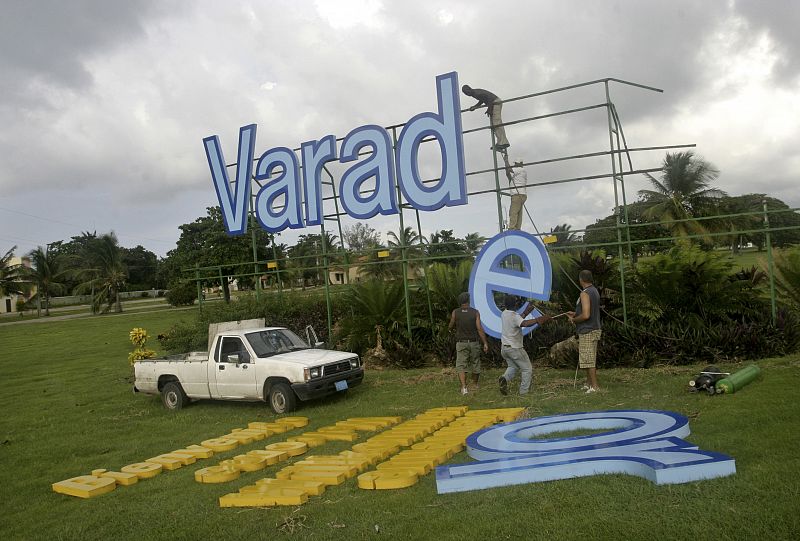 Workers dismantle a billboard at Varadero beach in Matanzas