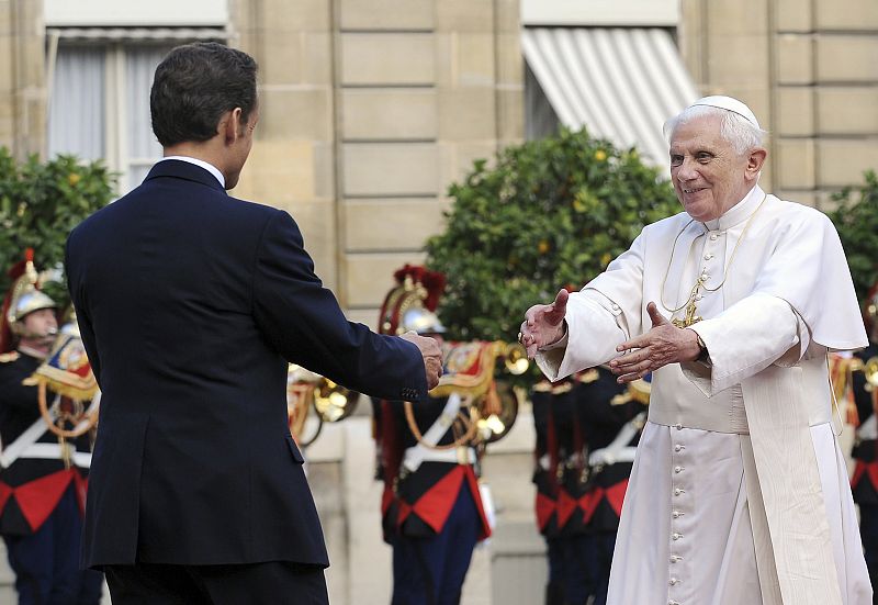 France's President Sarkozy welcomes Pope Benedict XVI in the courtyard of the Elysee Palace in Paris