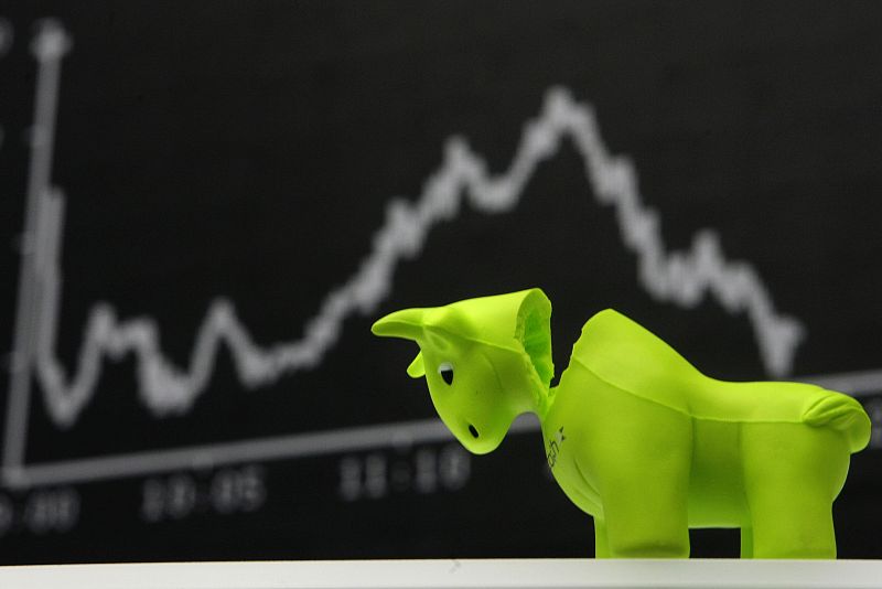 A bull styrofoam figure is pictured in front of the DAX board at the Frankfurt stock exchange