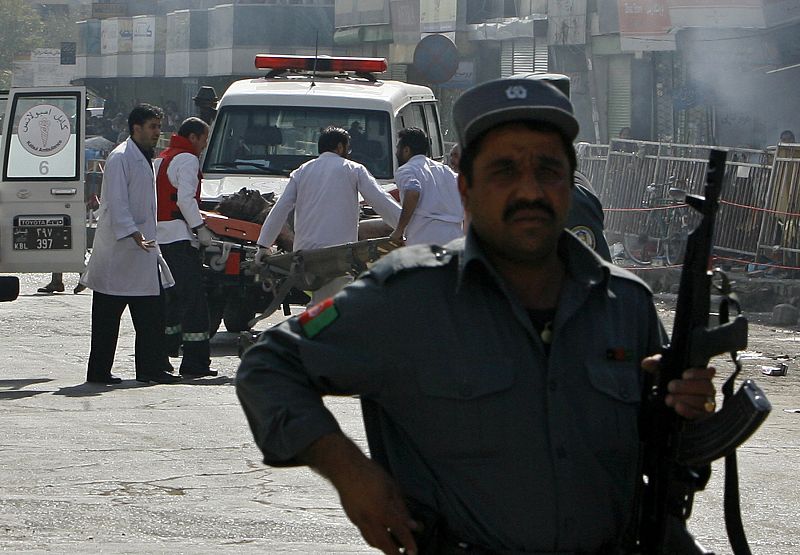 Afghan doctors help an injured man after a suicide attack in Kabul